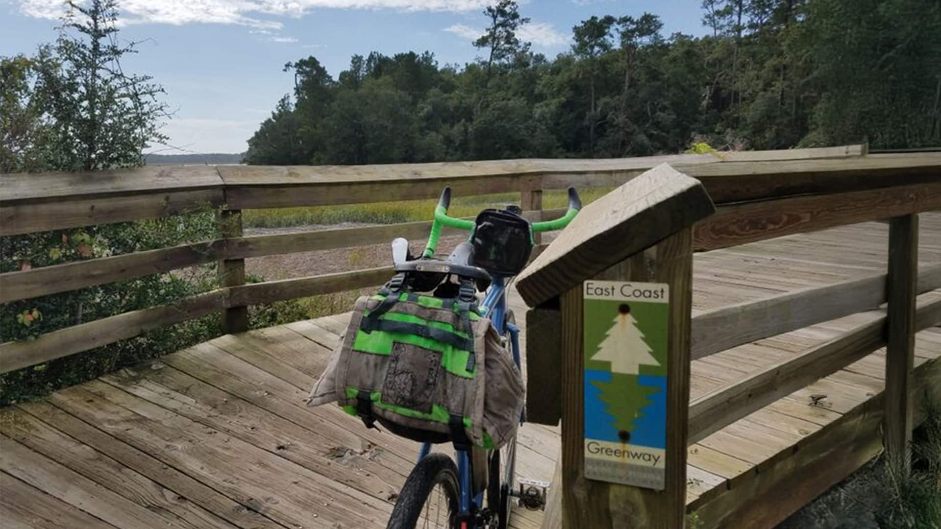 Bike leaning against wooden railing in SC on the trail