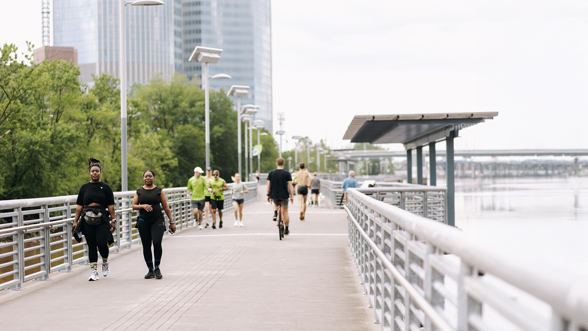 women walking on the boardwalk above the Schuylkill River