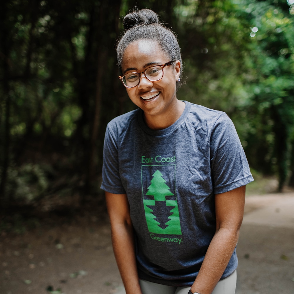 Woman in East Coast Greenway t-shirt laughing