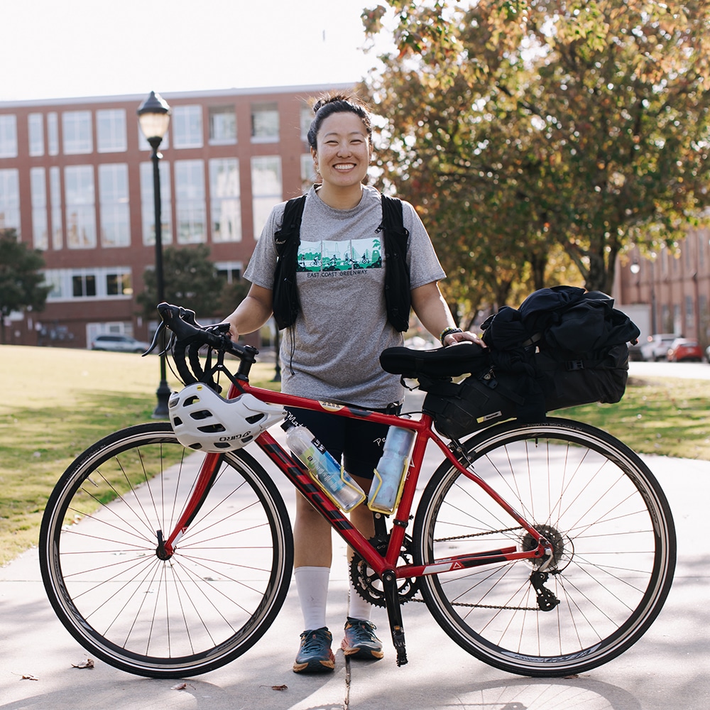 Whitney Kim smiling with bicycle