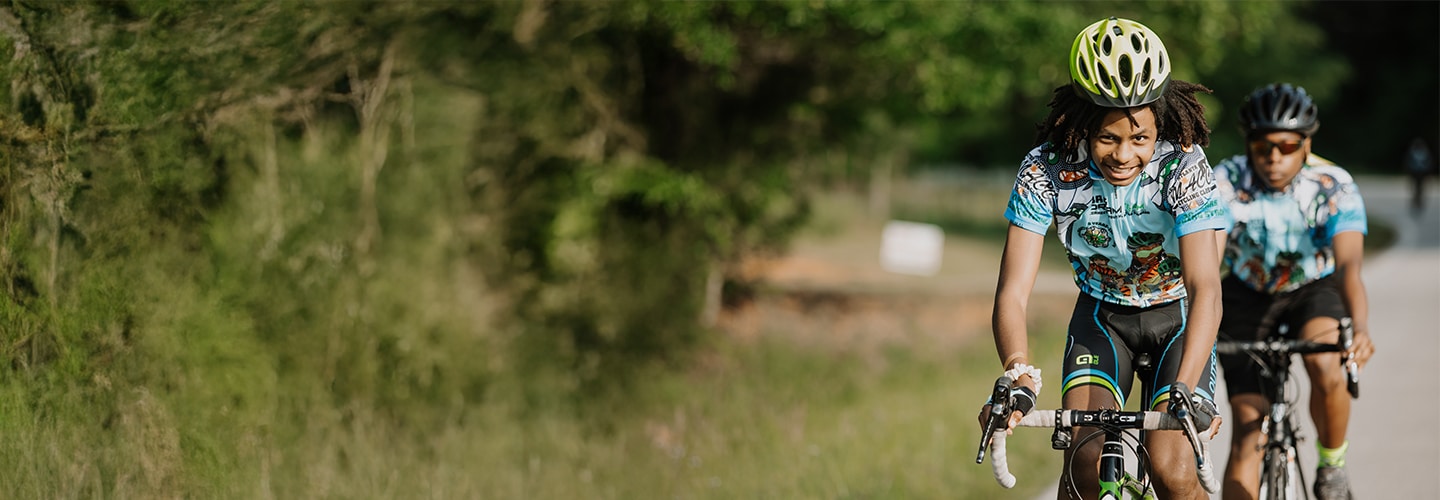 Teenager smiling riding on his bike