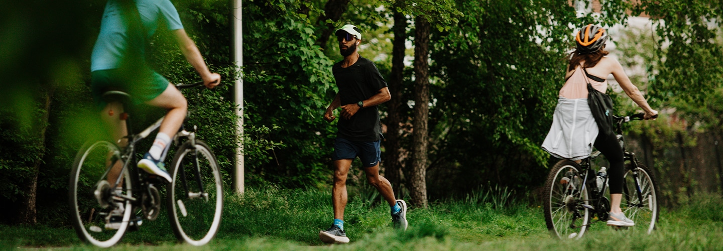 Man running on the East Coast Greenway with two cyclists
