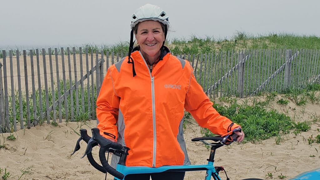 woman with bicycle on the beach
