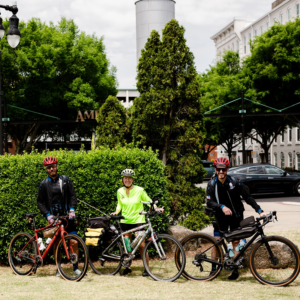 Three cyclists smiling